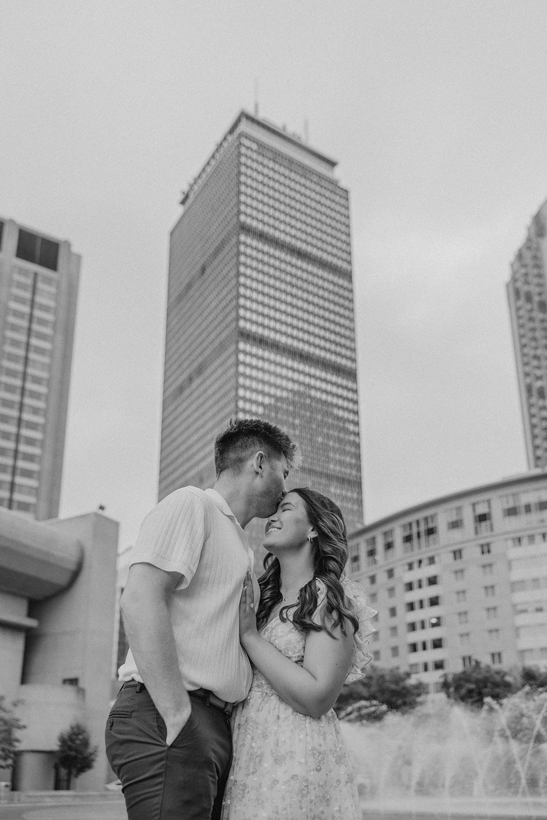 beautiful couple share an intimate moment with Boston in the background