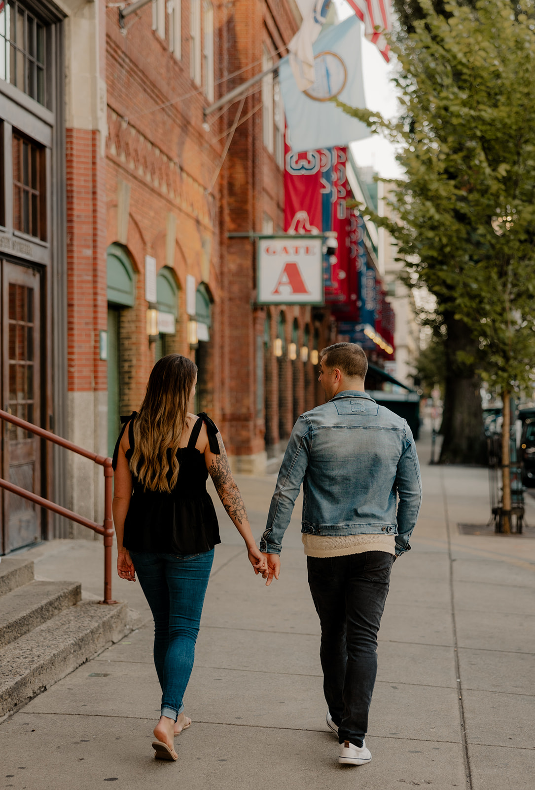 stunning couple pose together during their Boston anniversary photoshoot around Fenway Park