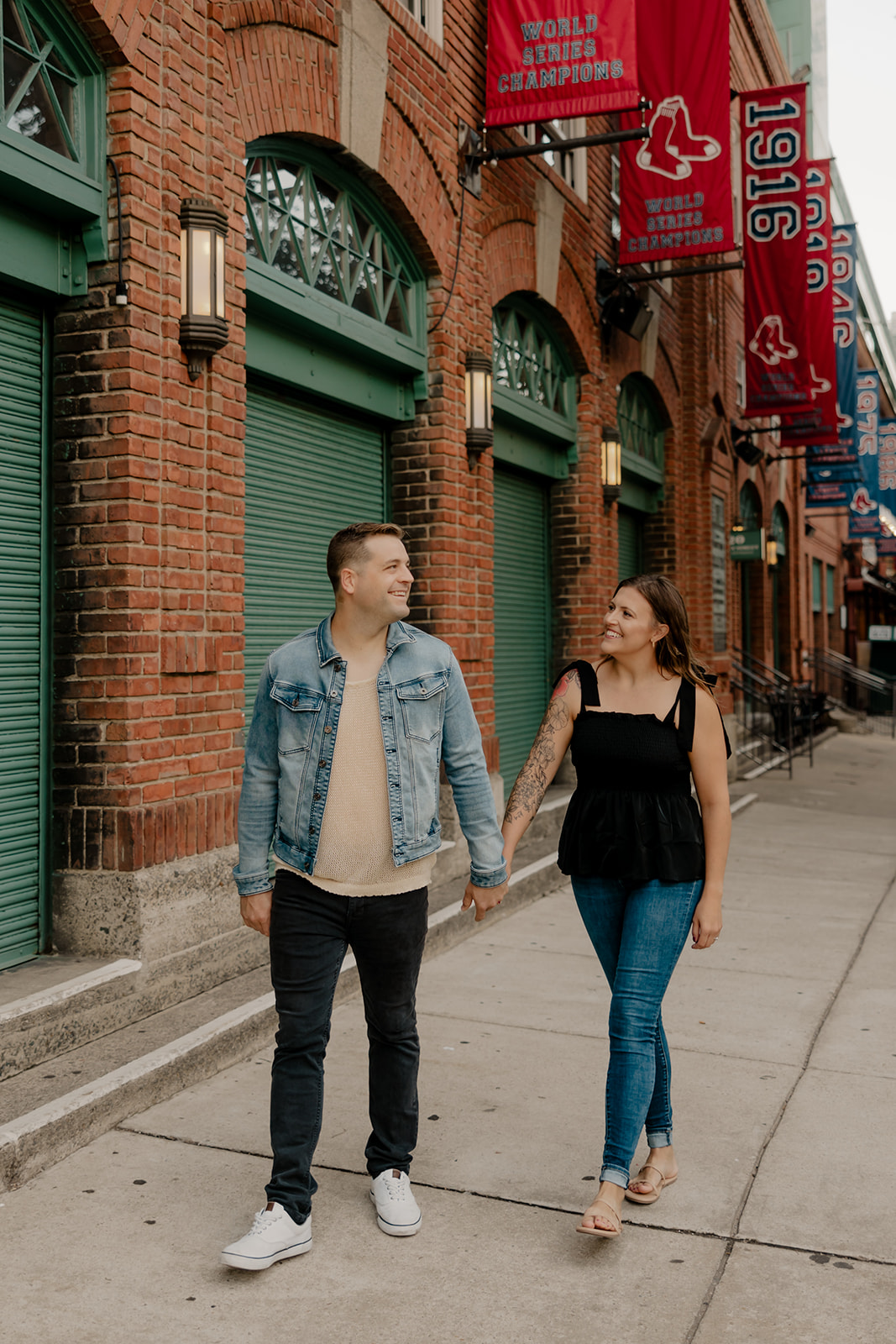 stunning couple pose together during their Boston anniversary photoshoot around Fenway Park