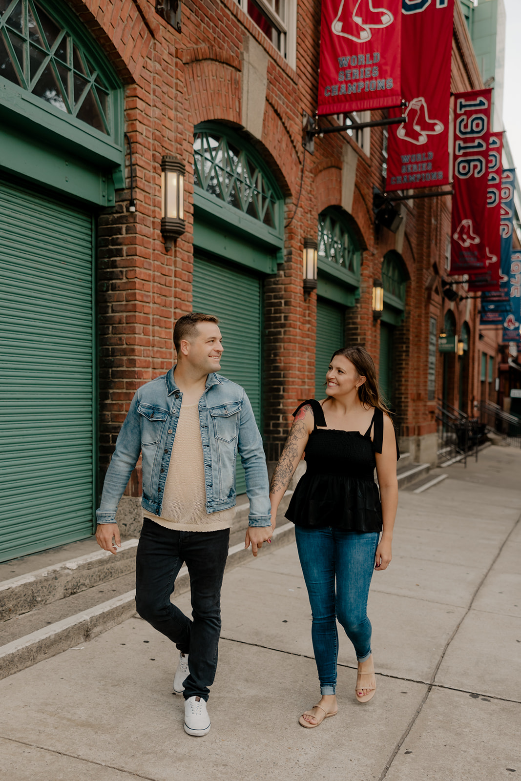 stunning couple pose together during their Boston anniversary photoshoot around Fenway Park