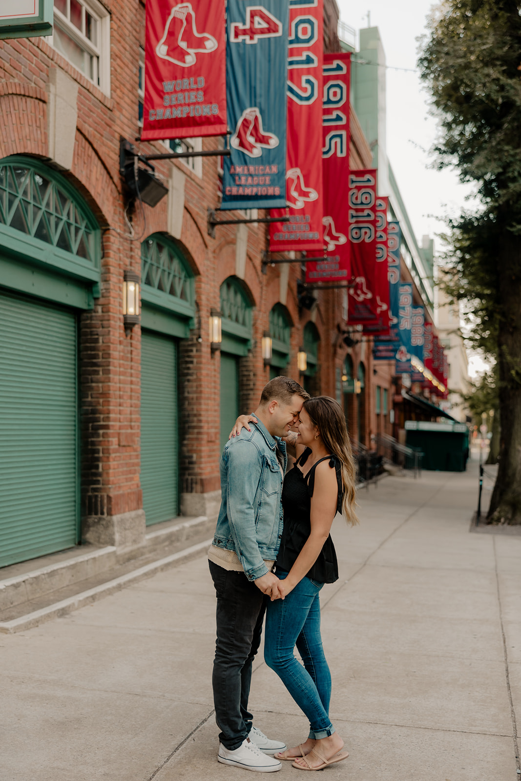 stunning couple pose together during their Boston anniversary photoshoot around Fenway Park