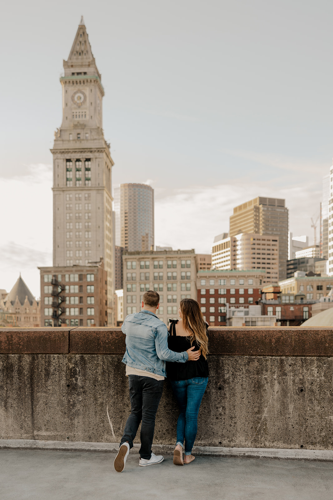 beautiful couple pose on a downtown Boston parking garage for their candid aanniversary photo shoot