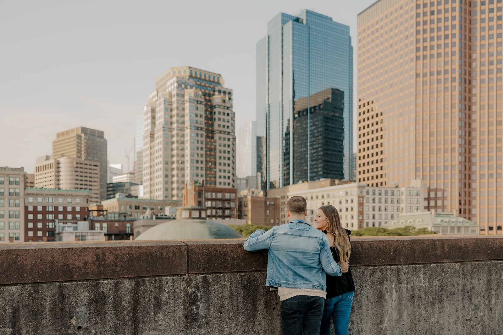 beautiful couple pose on a downtown Boston parking garage for their candid anniversary Boston photoshoot