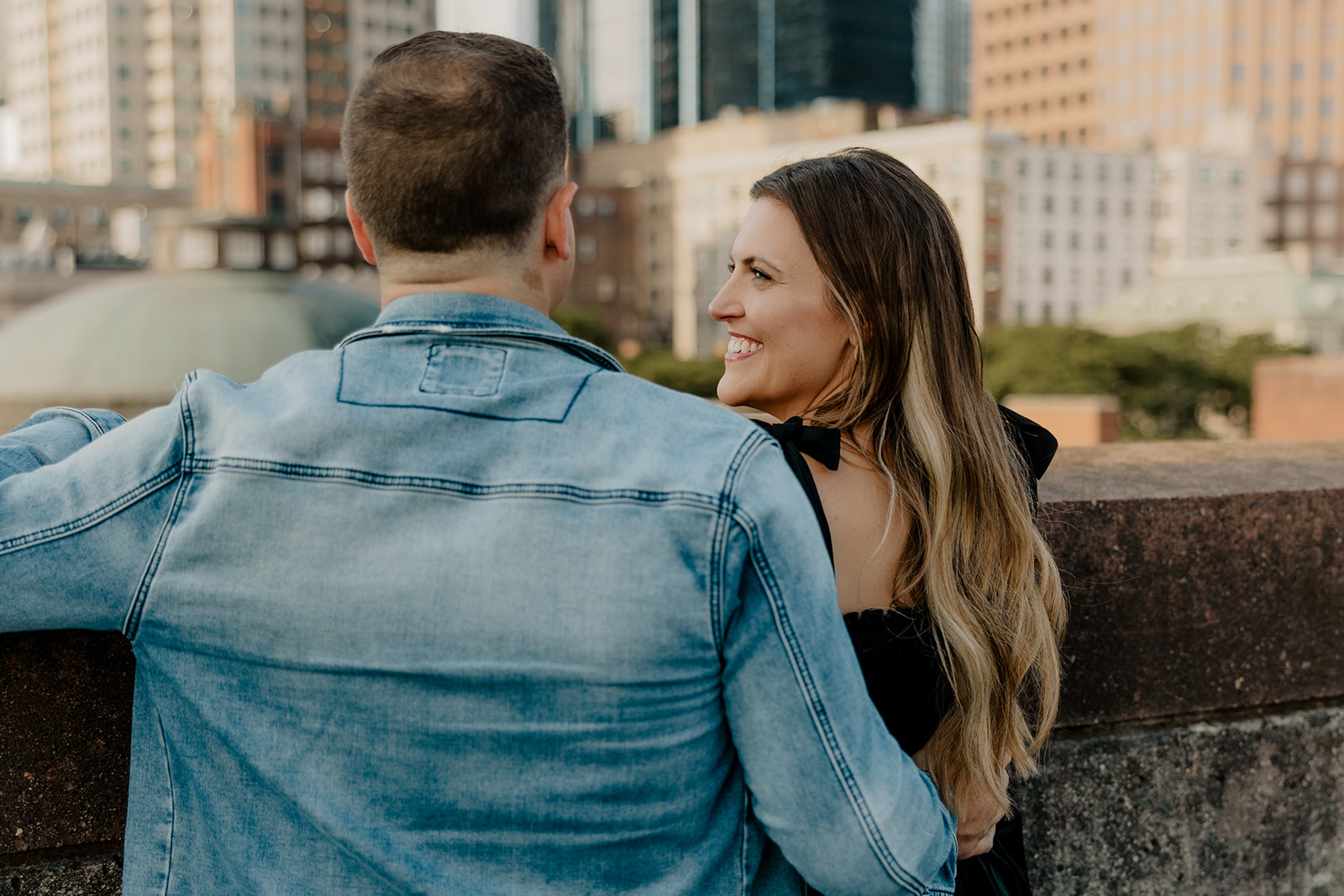 beautiful couple pose on a downtown Boston parking garage for their candid anniversary photo shoot