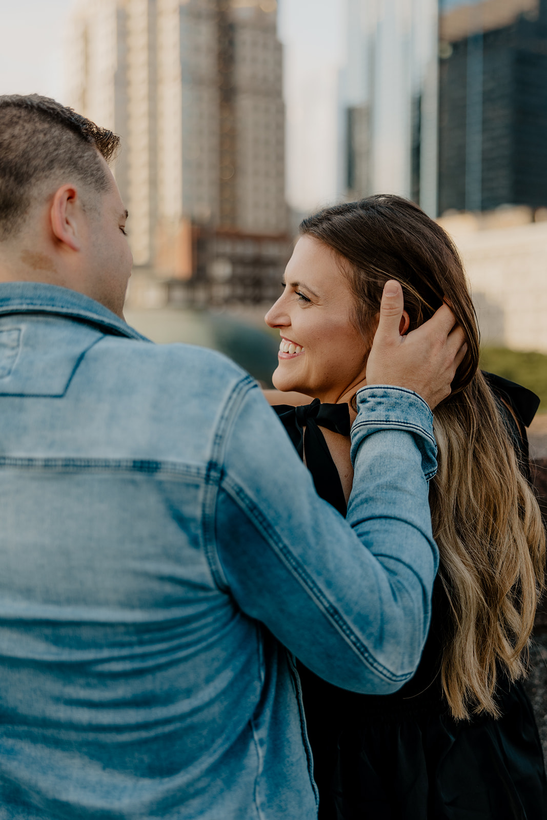 beautiful couple pose on a downtown Boston parking garage for their candid anniversary Boston photoshoot