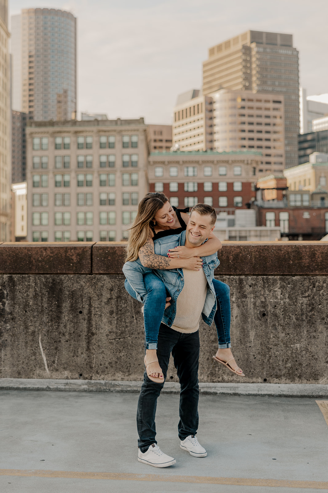 beautiful couple pose on a downtown Boston parking garage for their candid anniversary photo shoot