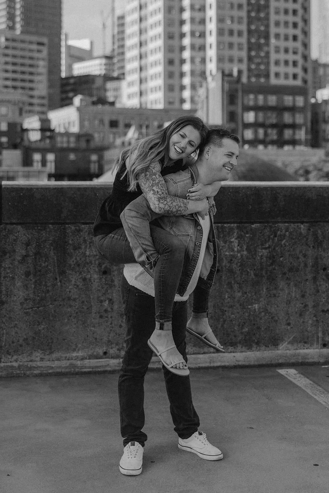 beautiful couple pose on a downtown Boston parking garage for their candid anniversary Boston photoshoot