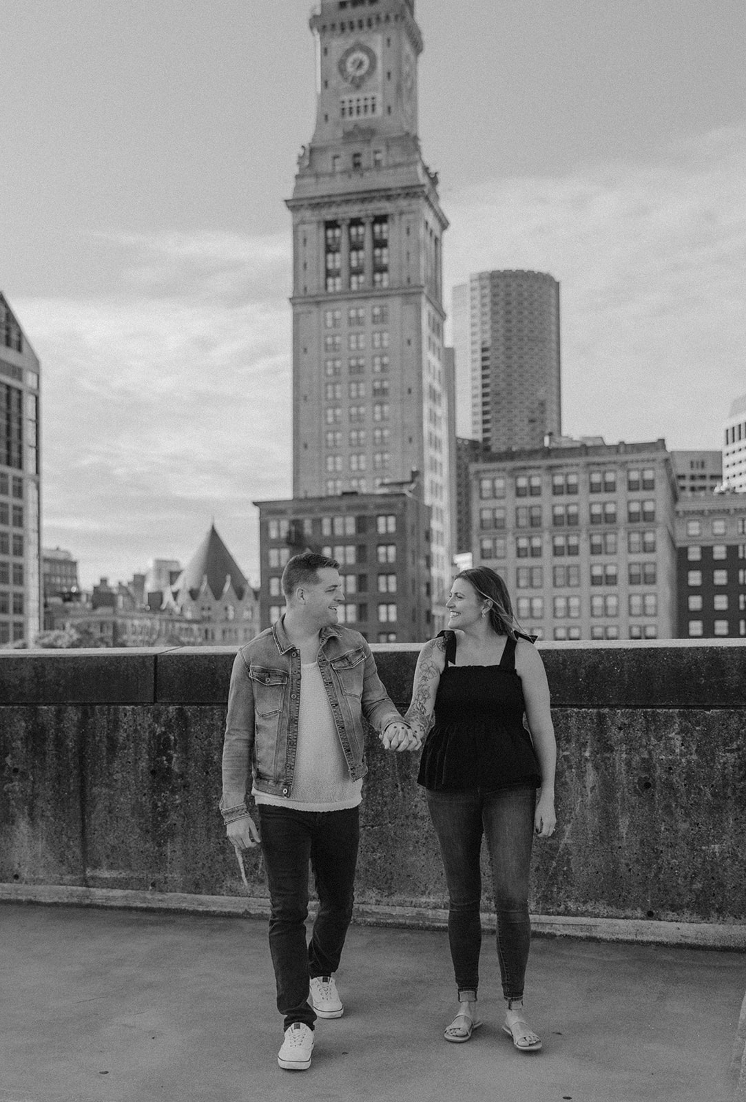 beautiful couple pose on a downtown Boston parking garage for their candid anniversary photo shoot