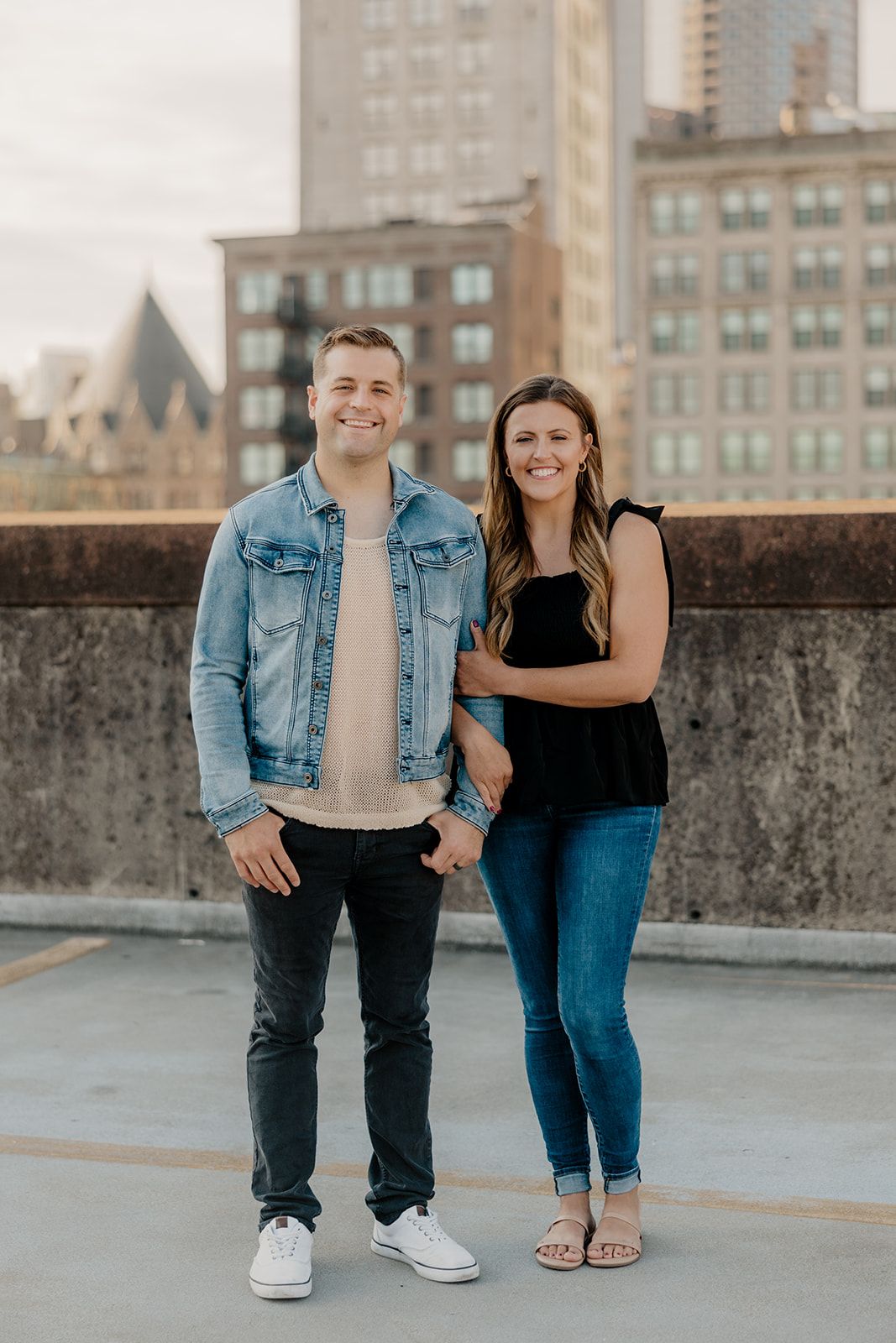 beautiful couple pose on a downtown Boston parking garage for their candid anniversary Boston photoshoot