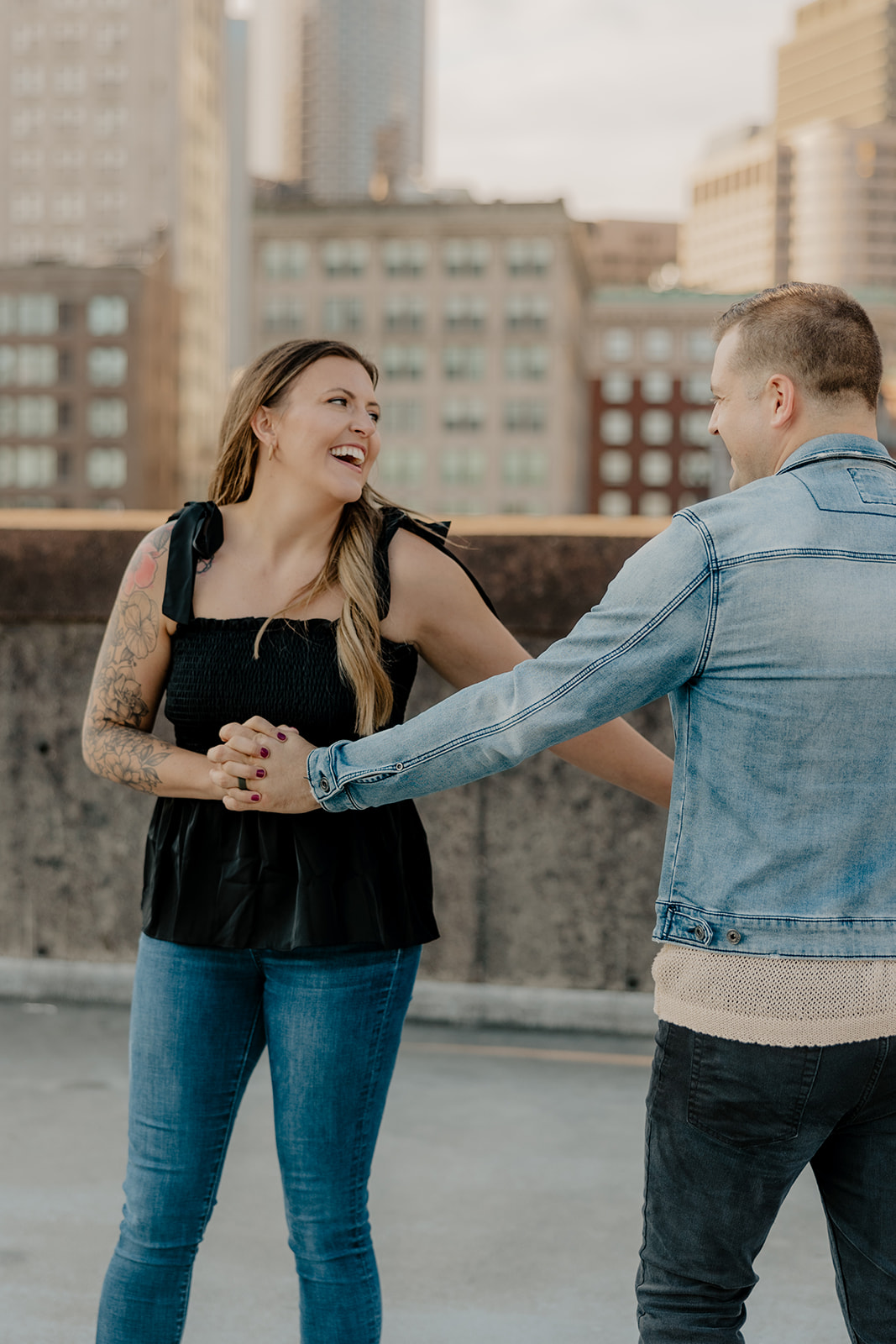 beautiful couple pose on a downtown Boston parking garage for their candid anniversary Boston photoshoot