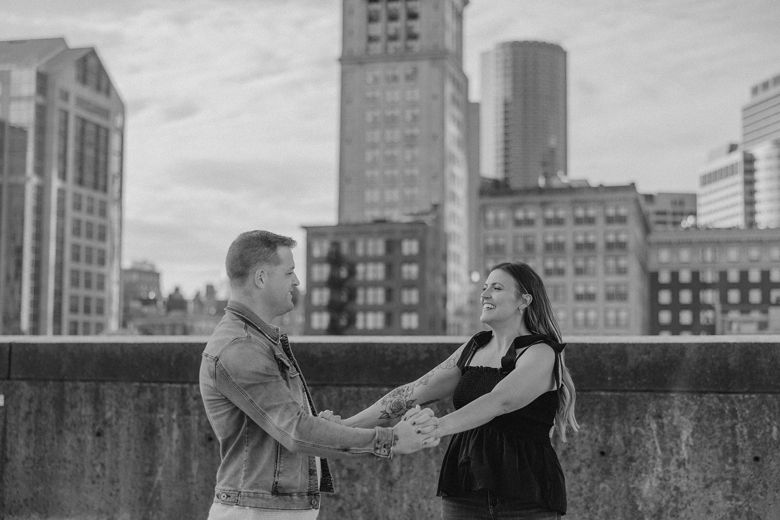 beautiful couple pose on a downtown Boston parking garage for their candid anniversary Boston photoshoot