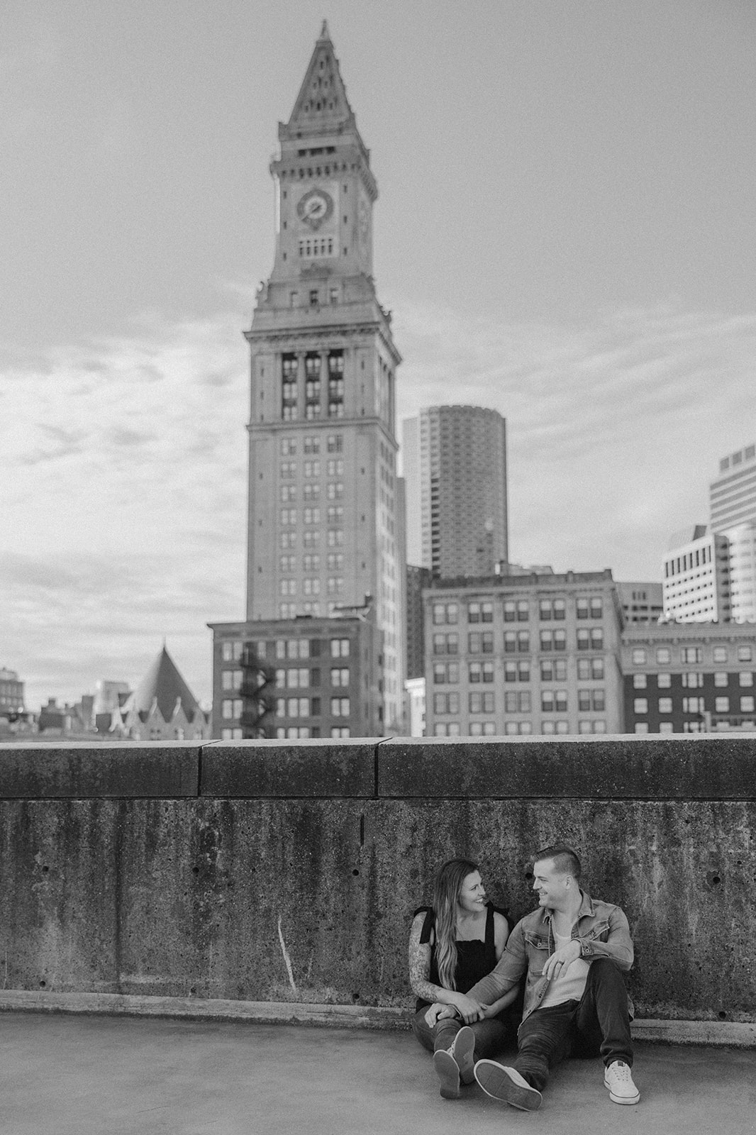 beautiful couple pose on a downtown Boston parking garage for their candid anniversary Boston photoshoot