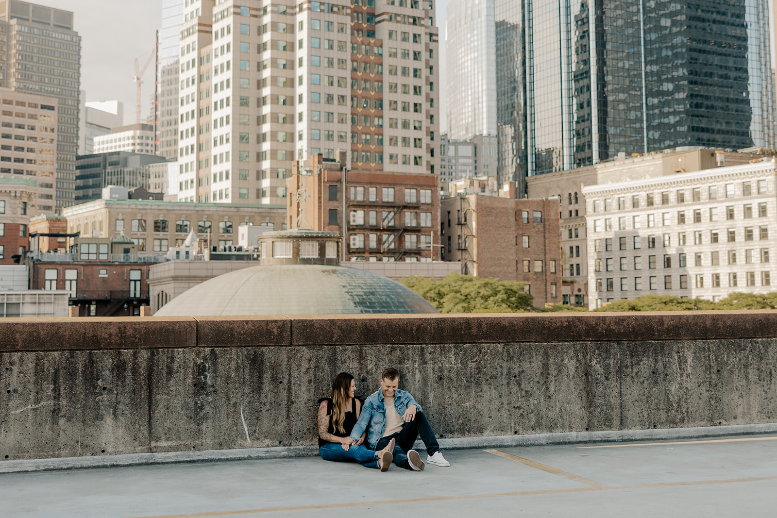 beautiful couple pose on a downtown Boston parking garage for their candid anniversary Boston photoshoot