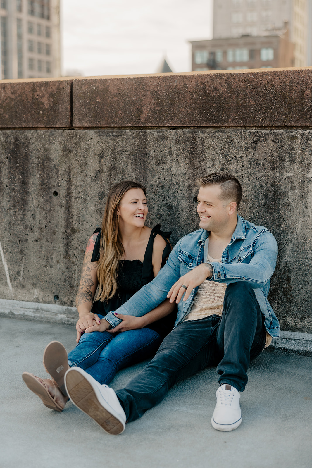 beautiful couple pose on a downtown Boston parking garage for their candid anniversary photo shoot