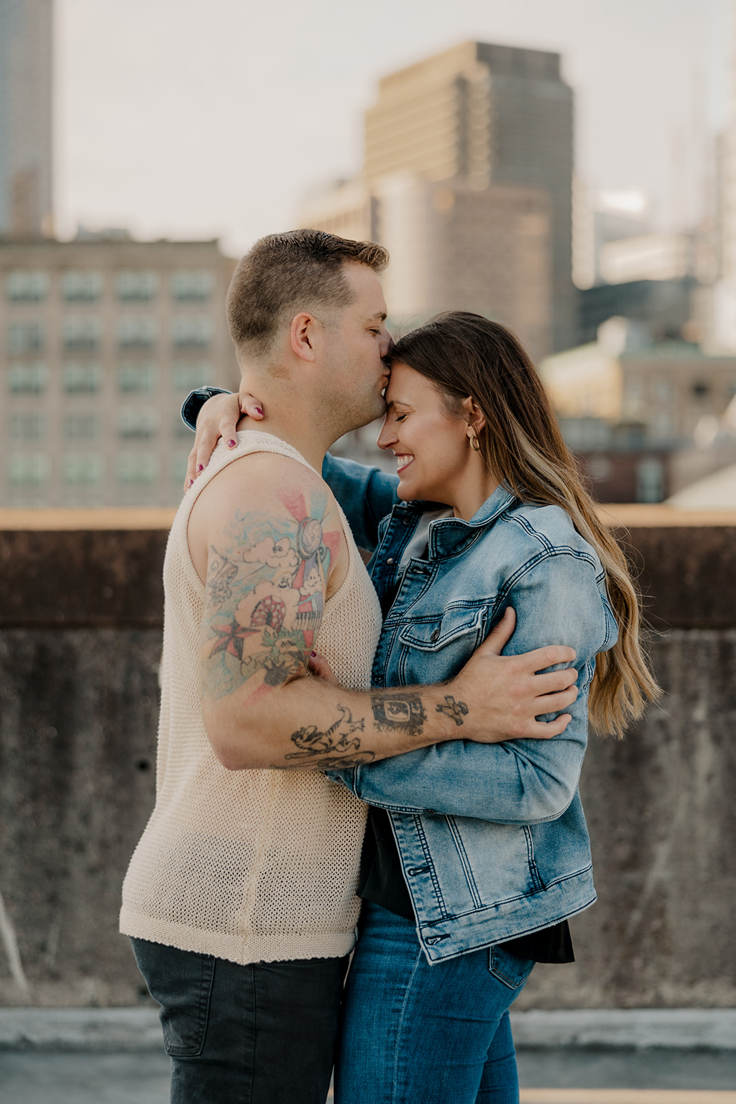 beautiful couple pose on a downtown Boston parking garage for their candid anniversary photo shoot