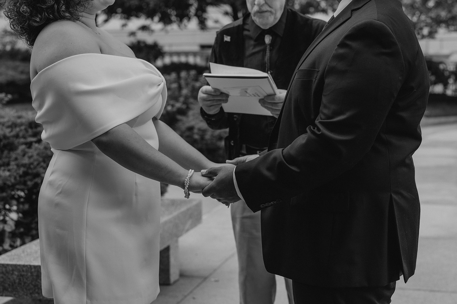 bride and groom hold hands during their state house elopement