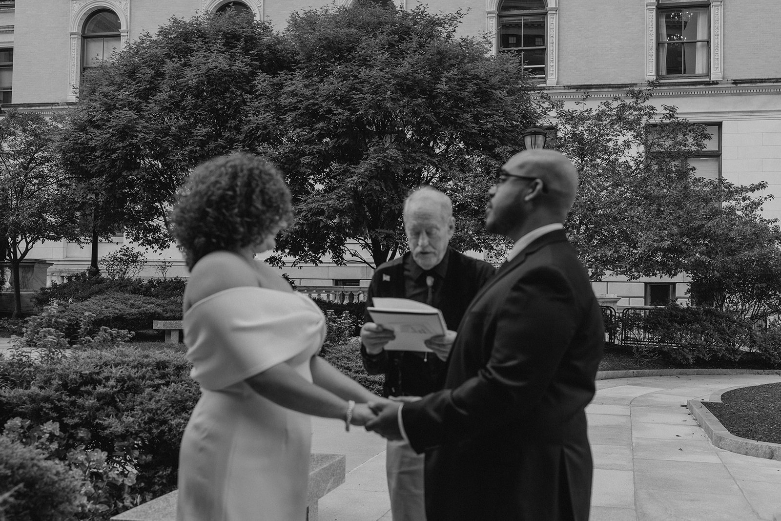 bride and groom hold hands during their state house elopement