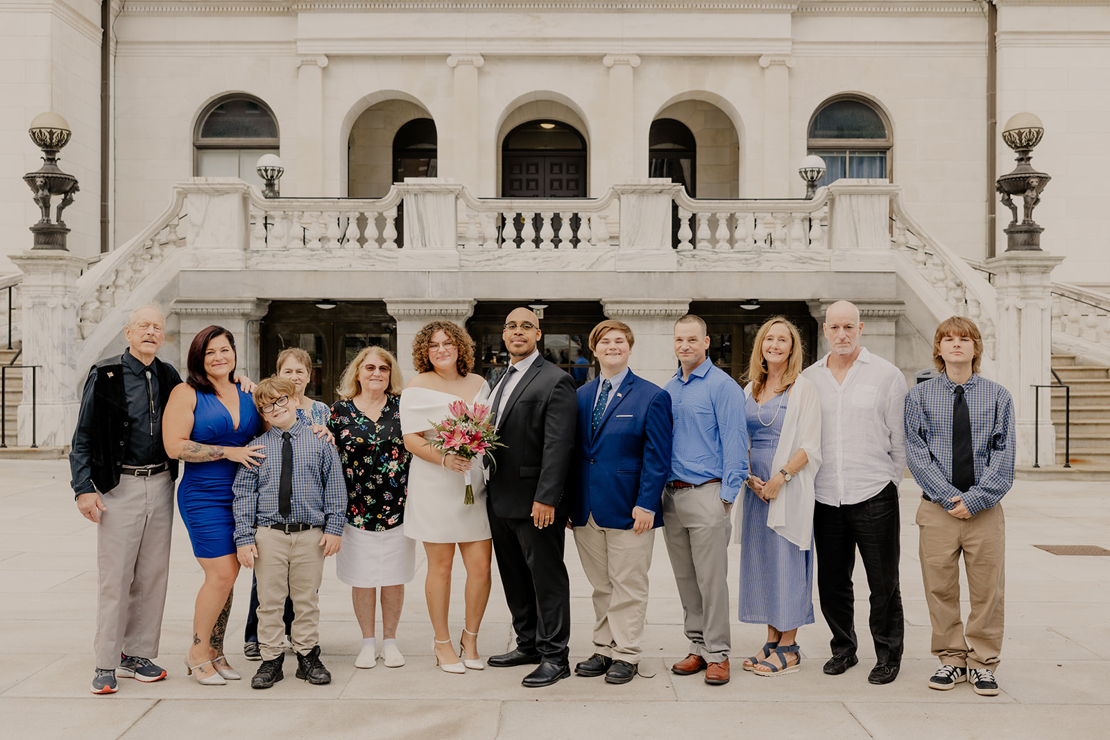 bride and groom pose with their family after their boston elopement