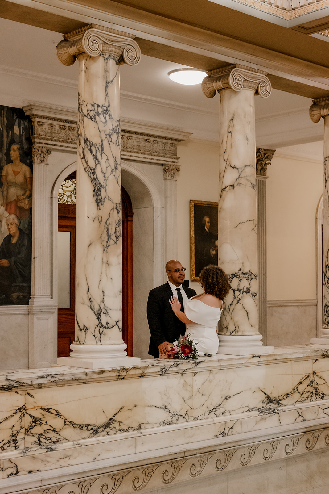 stunning bride and groom stop for a picture during their state house elopement