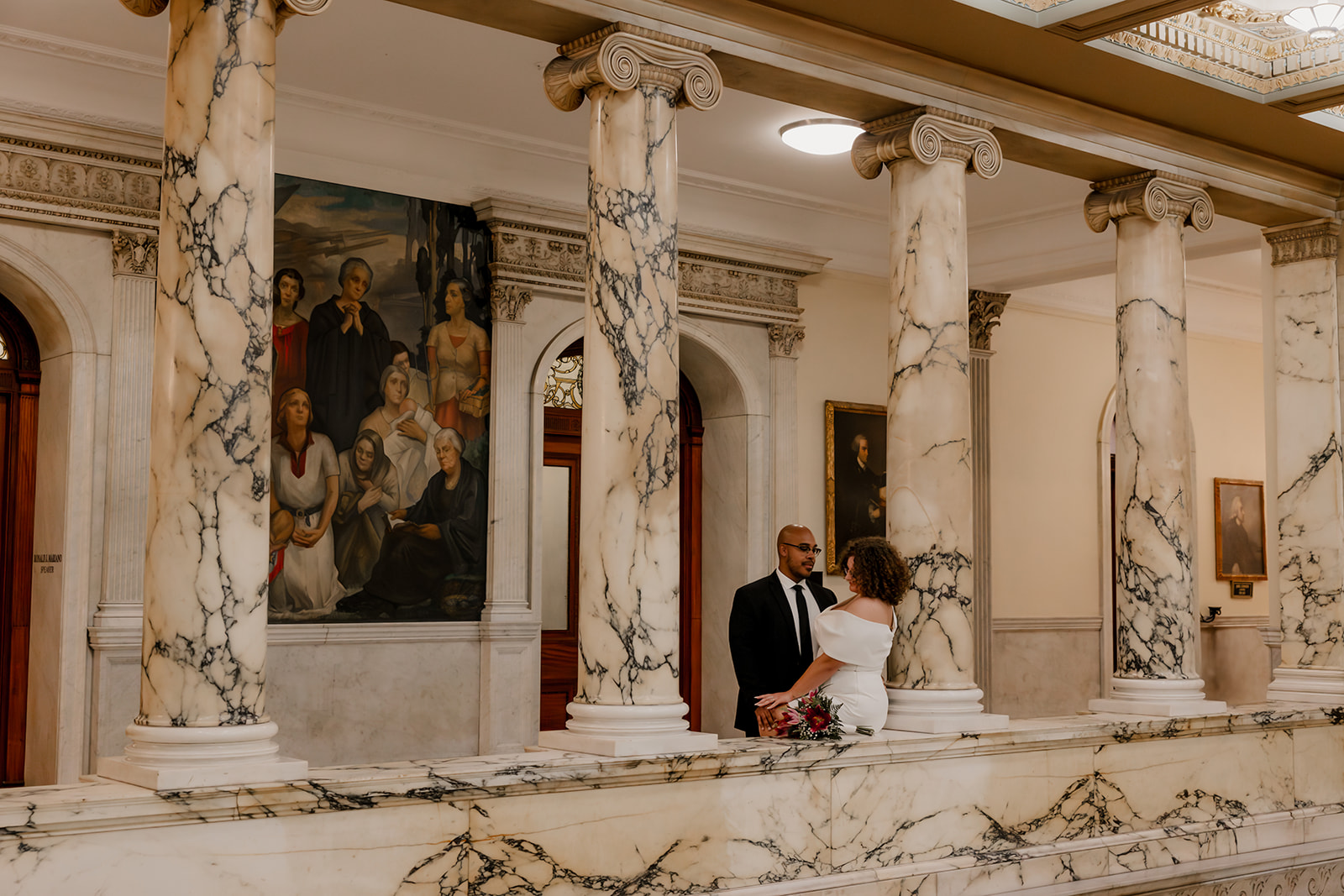 stunning bride and groom stop for a picture during their state house elopement