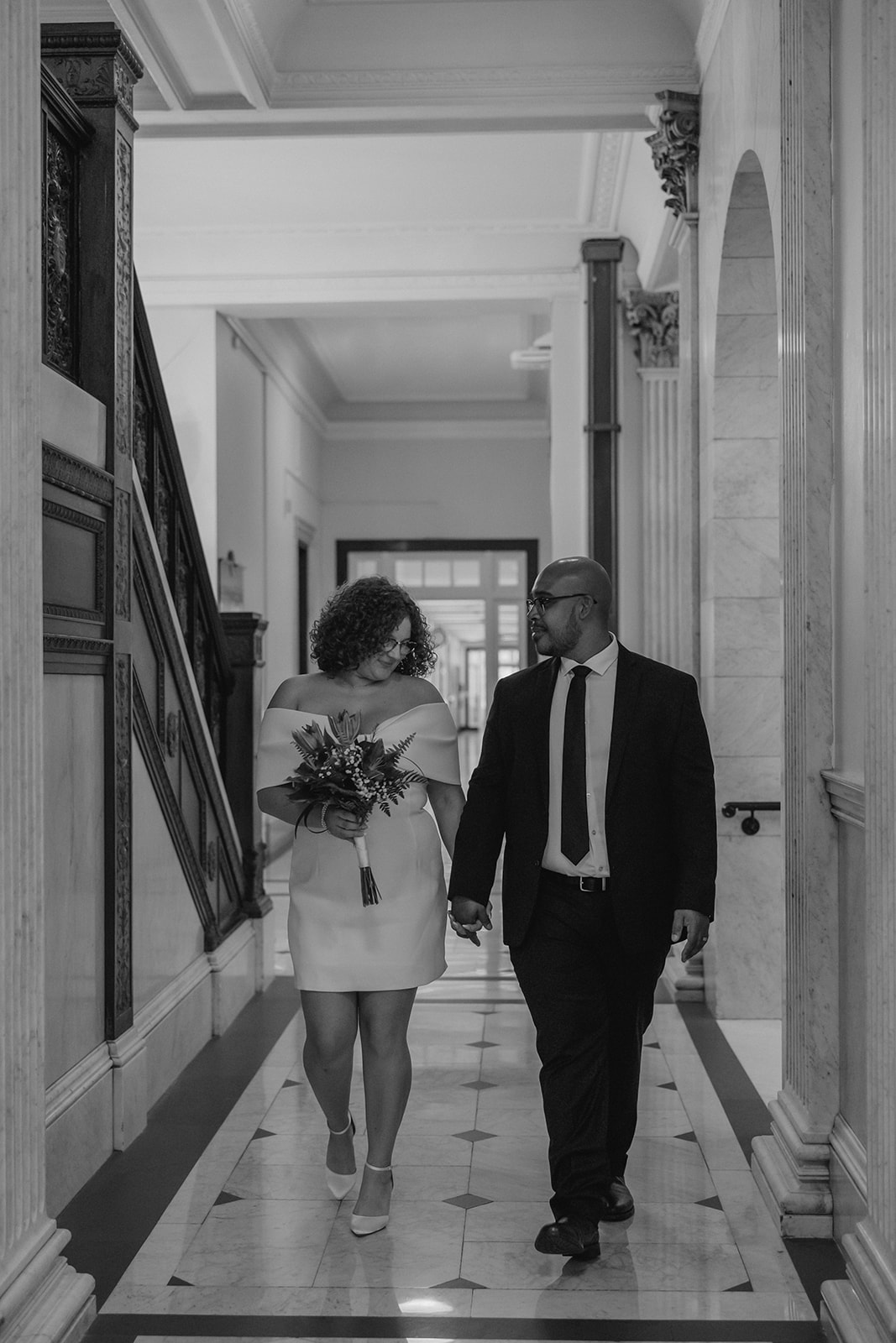 stunning bride and groom stop for a picture during their state house elopement