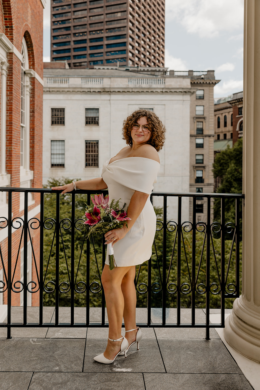 beautiful bride poses on the state house balcony