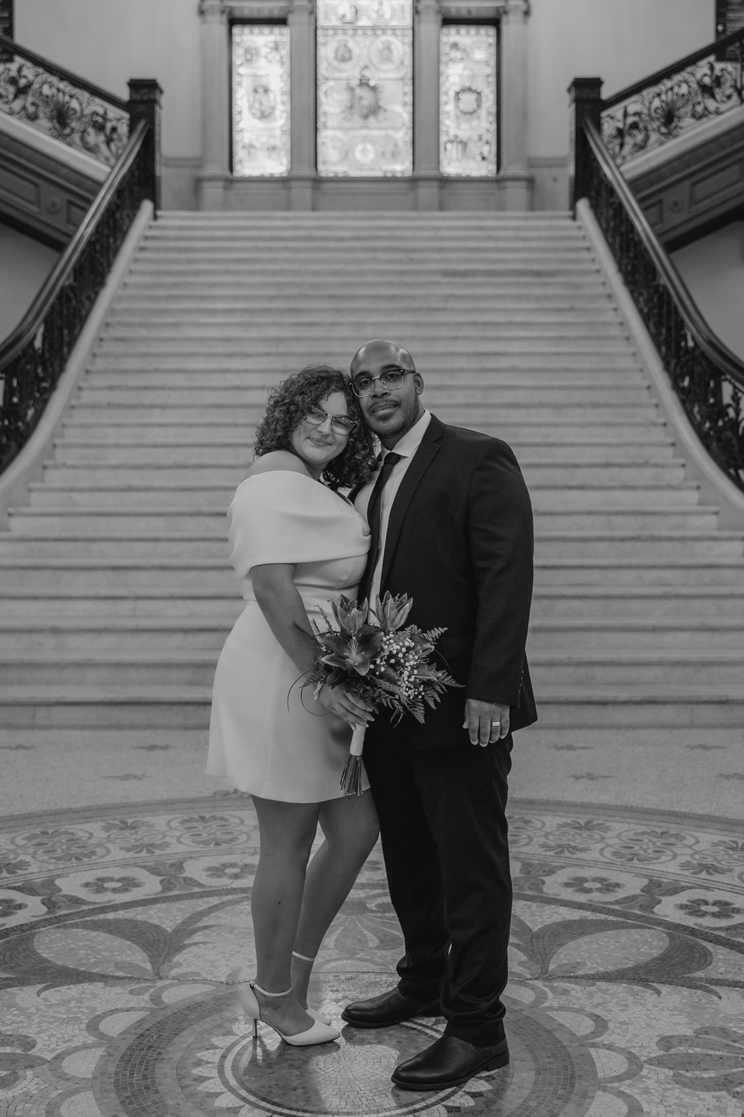 stunning bride and groom stop for a picture during their state house elopement