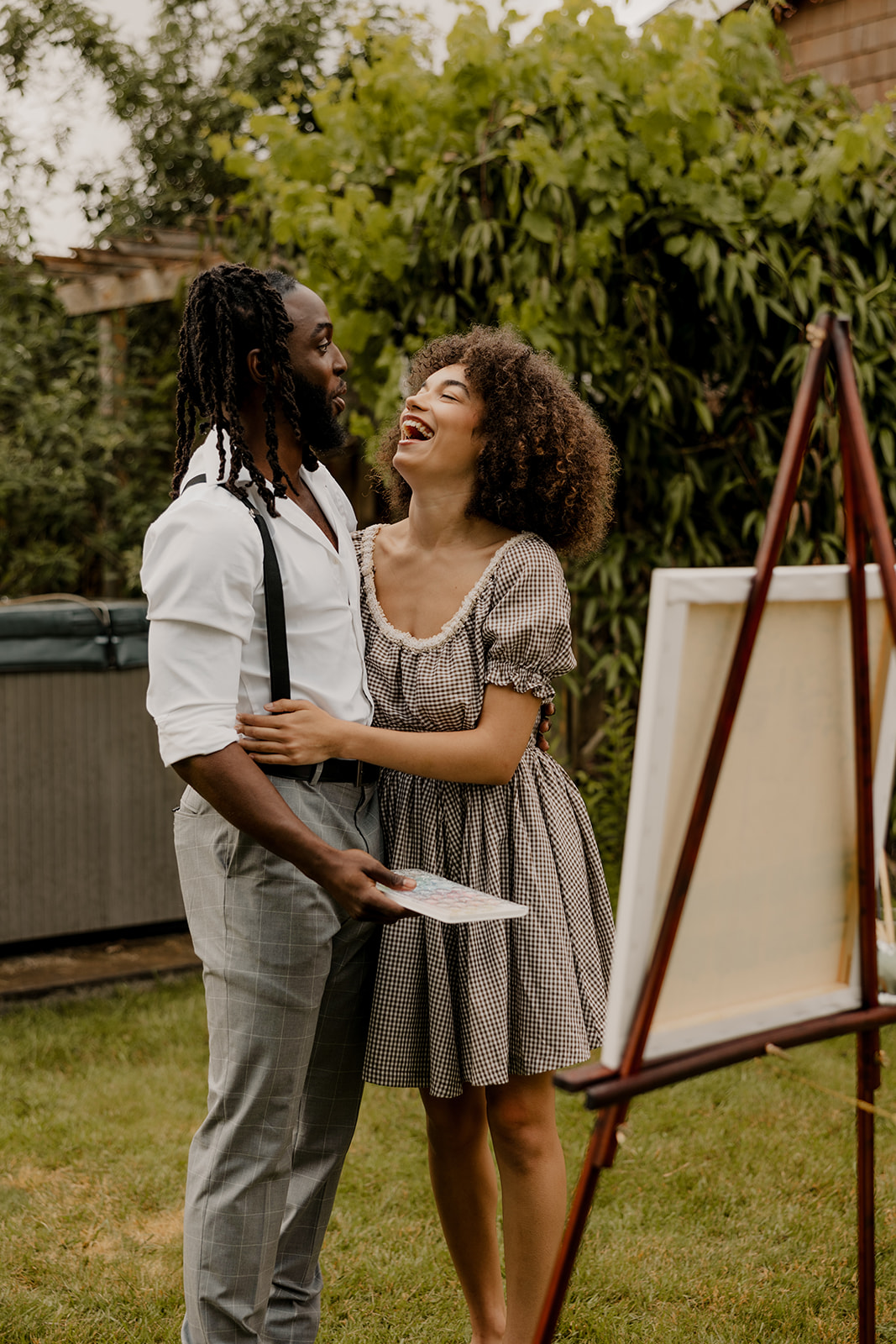 beautiful couple pose together in the backyard