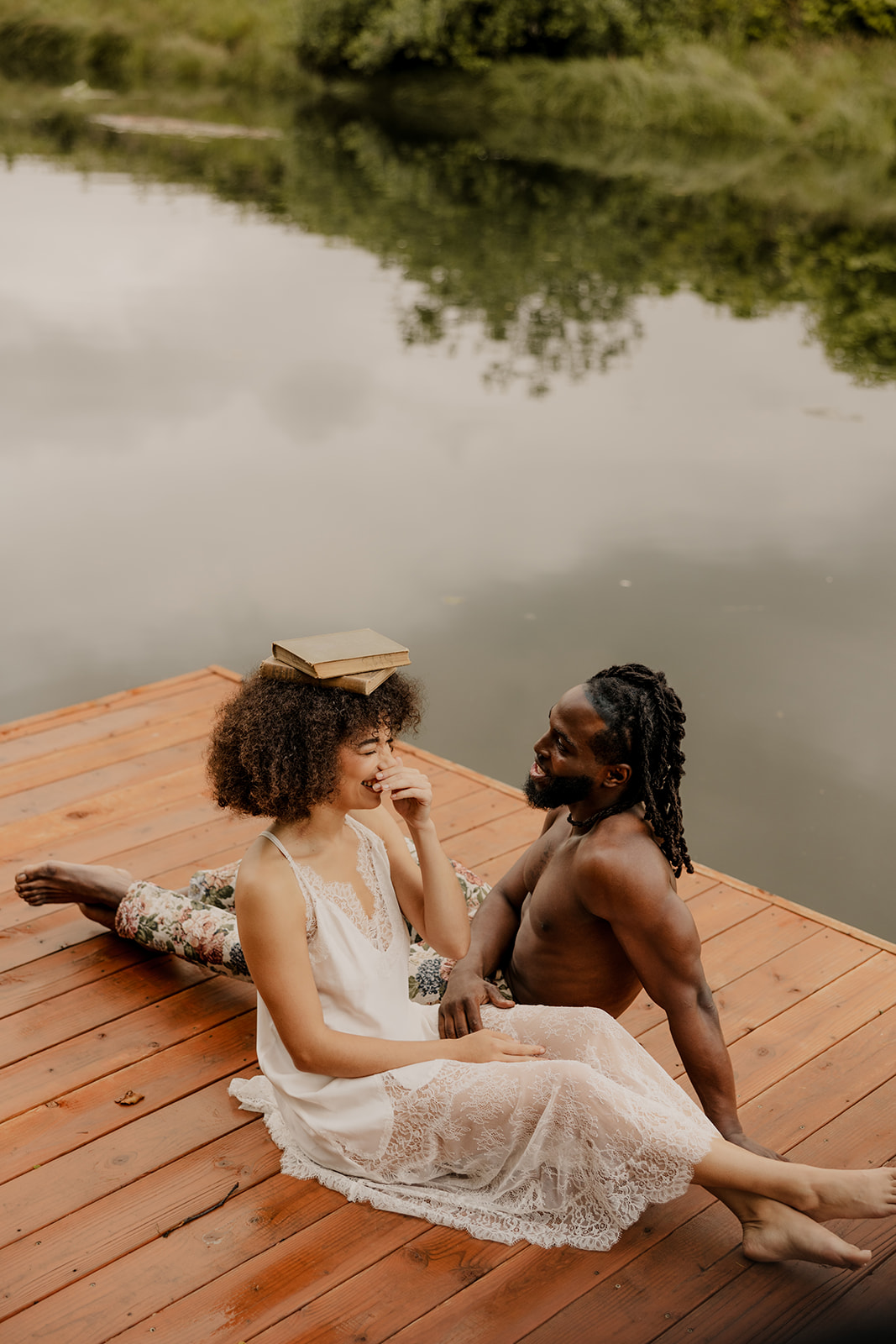 beautiful couple pose together on a dock