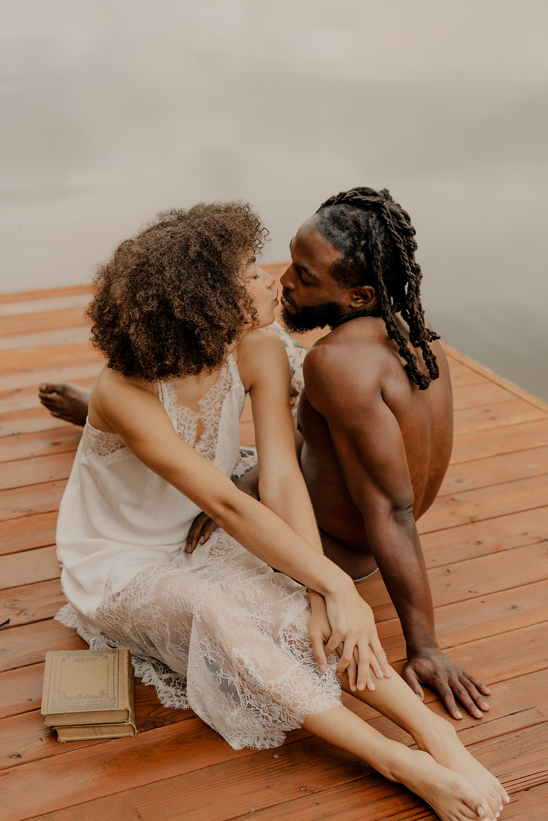 beautiful couple pose together on a dock