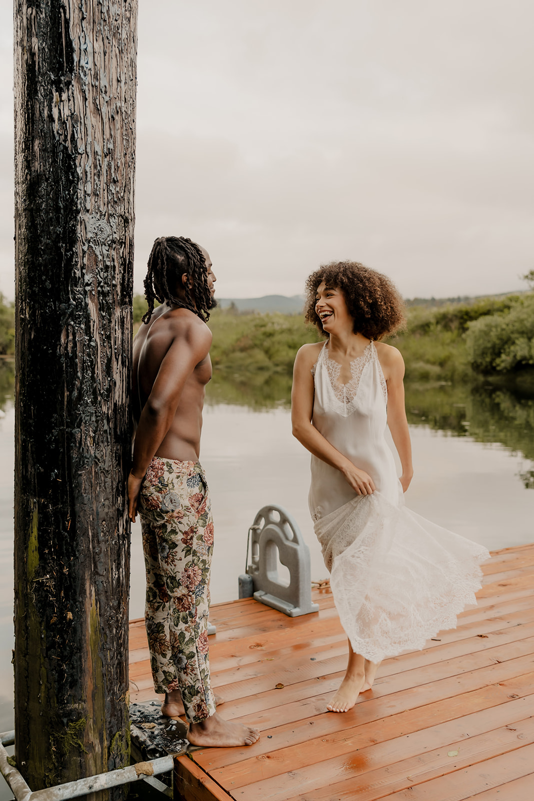 beautiful couple pose together on a dock