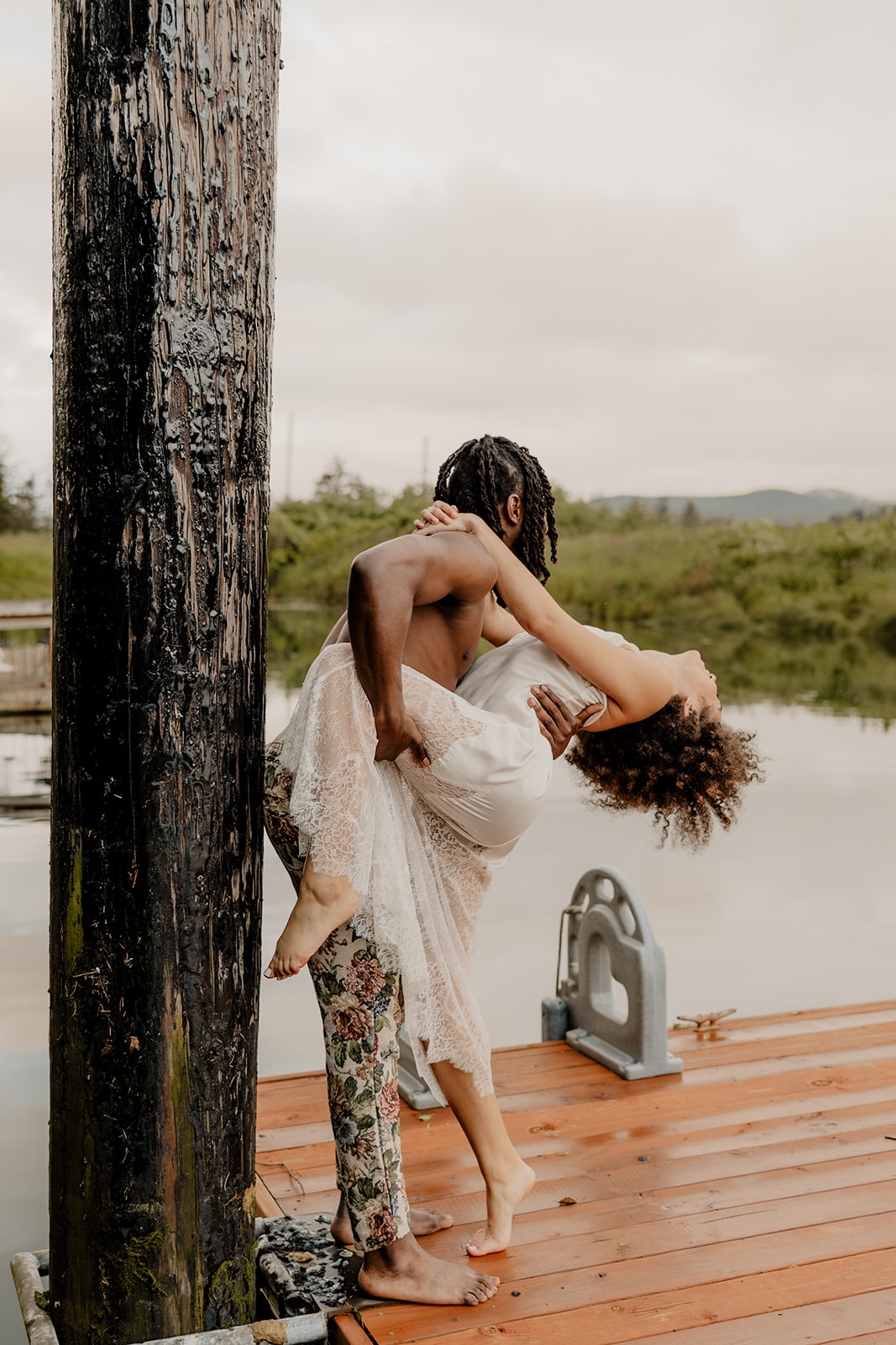 beautiful couple pose together on a dock