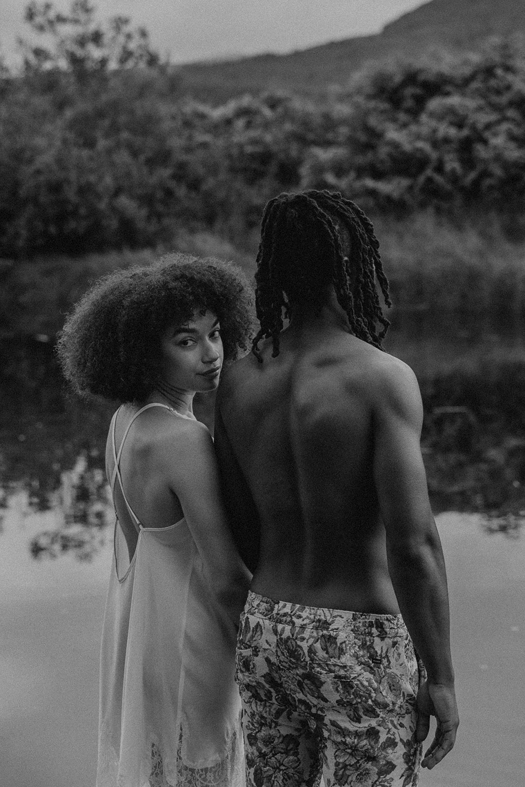 beautiful couple pose together on a dock