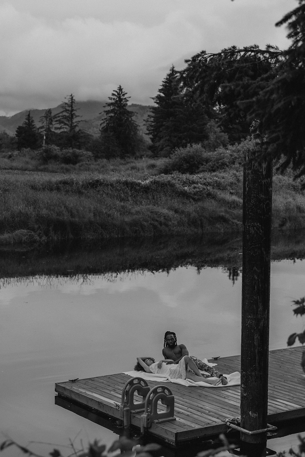 beautiful couple pose together on a dock