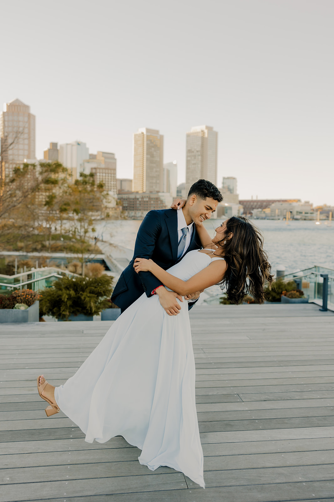 stunning couple pose together with Boston in the background