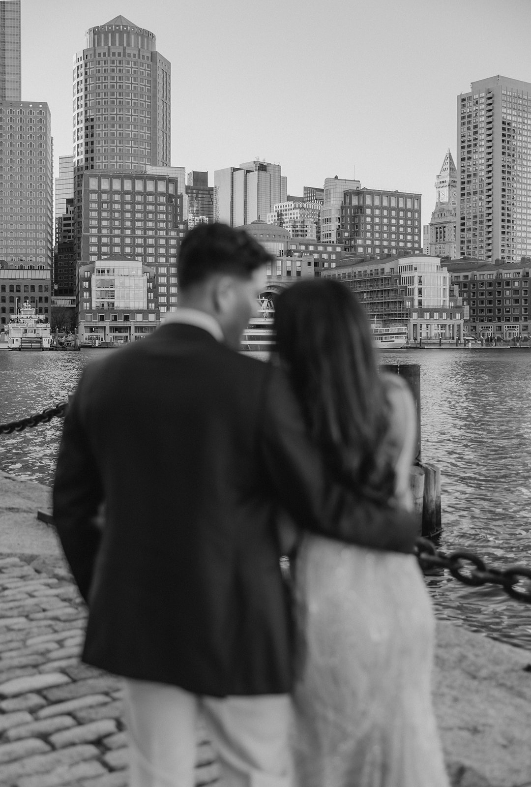 stunning couple pose together with Boston in the background